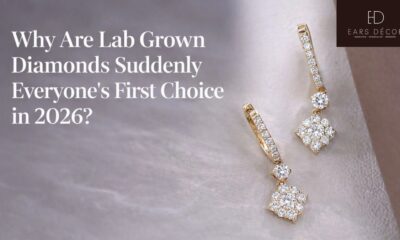 A pair of gold diamond cluster drop earrings by Ears Décor, showcasing sparkling lab grown diamonds set in yellow gold, elegantly resting on a soft white textured surface.