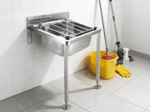 Wall-mounted stainless utility mop sink with wire grate and front legs for compact janitorial closets and facility floor maintenance