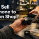 Person selling an old phone at a pawn shop